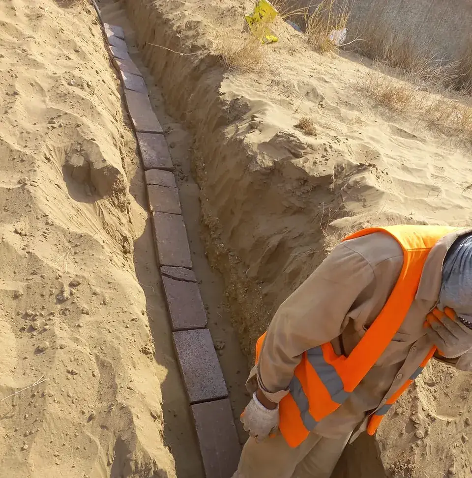 Cable trench with protective tiles