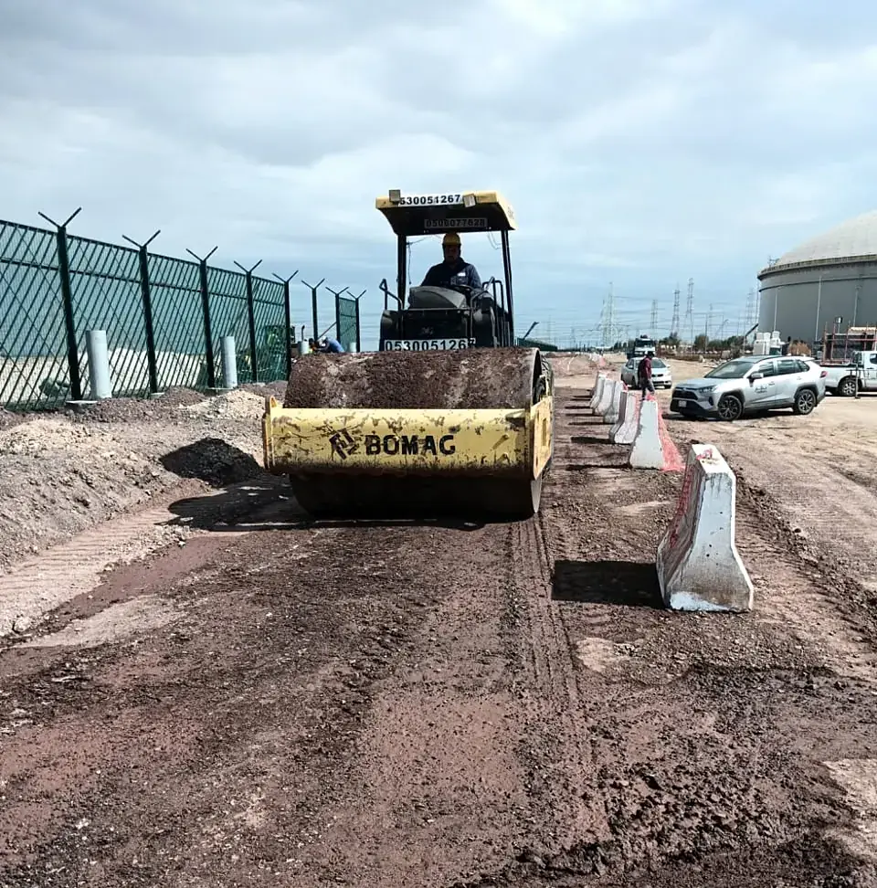 Vibratory roller compacting the road subgrade