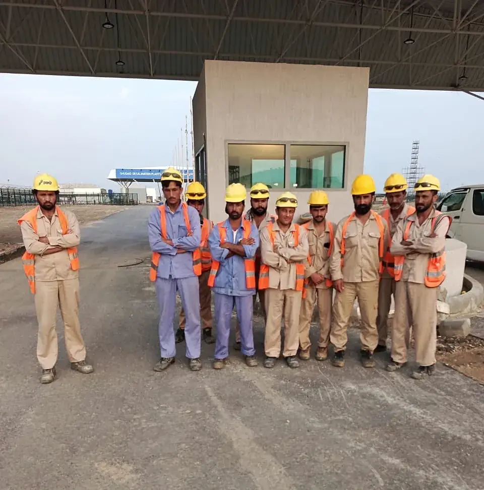 Site crew in front of a completed gatehouse